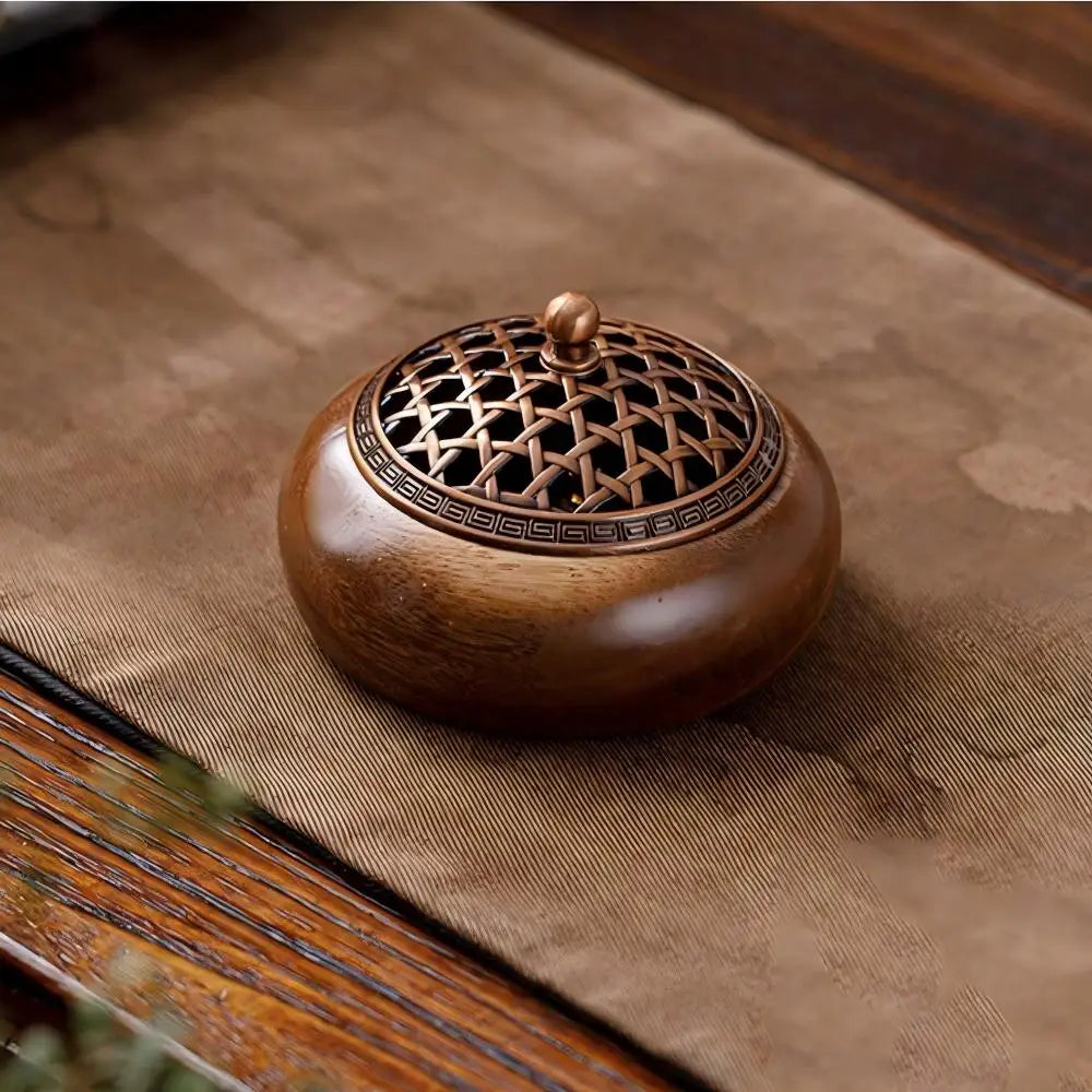 Wood incense burner with round lid, lattice pattern, and central bronze knob
