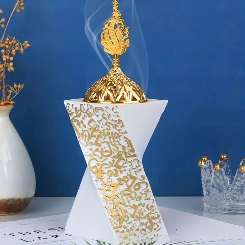 White resin bakhoor burner with gold decorative top and engraved Arabic pattern