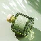 50ml reed diffuser bottle with label and green glass, angled close-up
