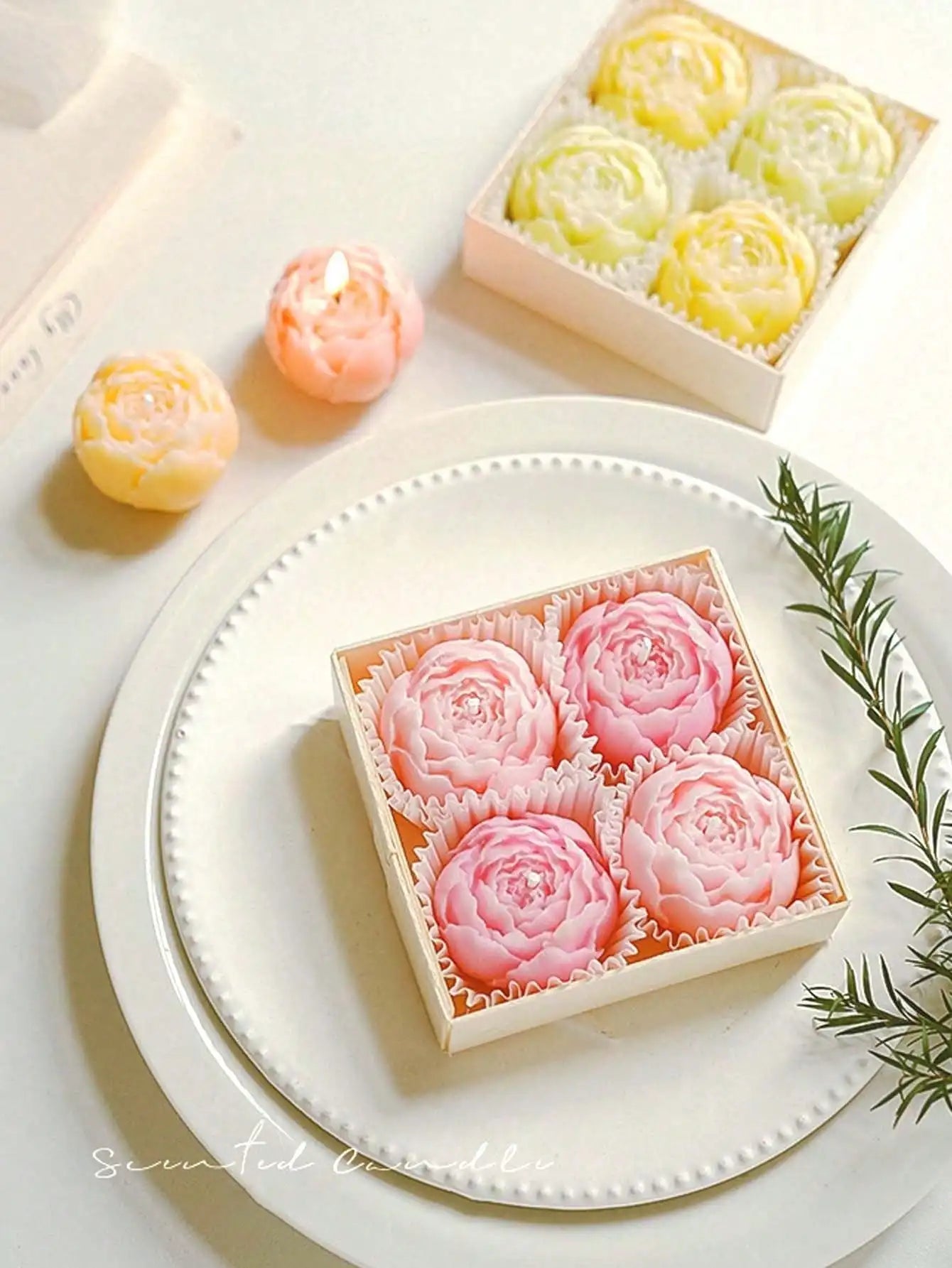 Floral candle set: yellow and pastel rose candles in boxes and around plate