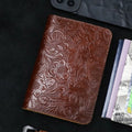 Cognac brown embossed leather travel folio with floral motifs and textured finish