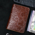 Cognac brown embossed leather travel folio with floral motifs and textured finish