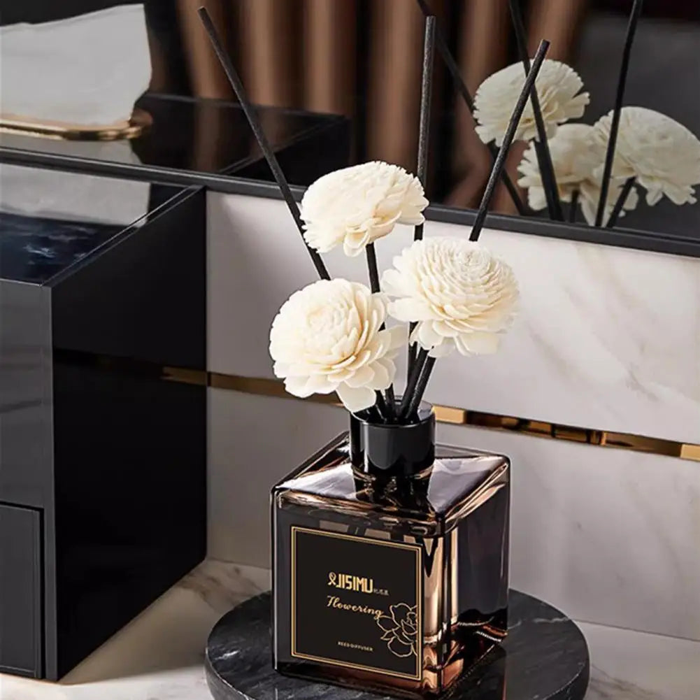 Classic reed diffuser set: black reeds with white flower heads on a square dark bottle