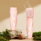 Pink electric hair bakhoor diffuser with comb-style heat plate, vapor rising from top