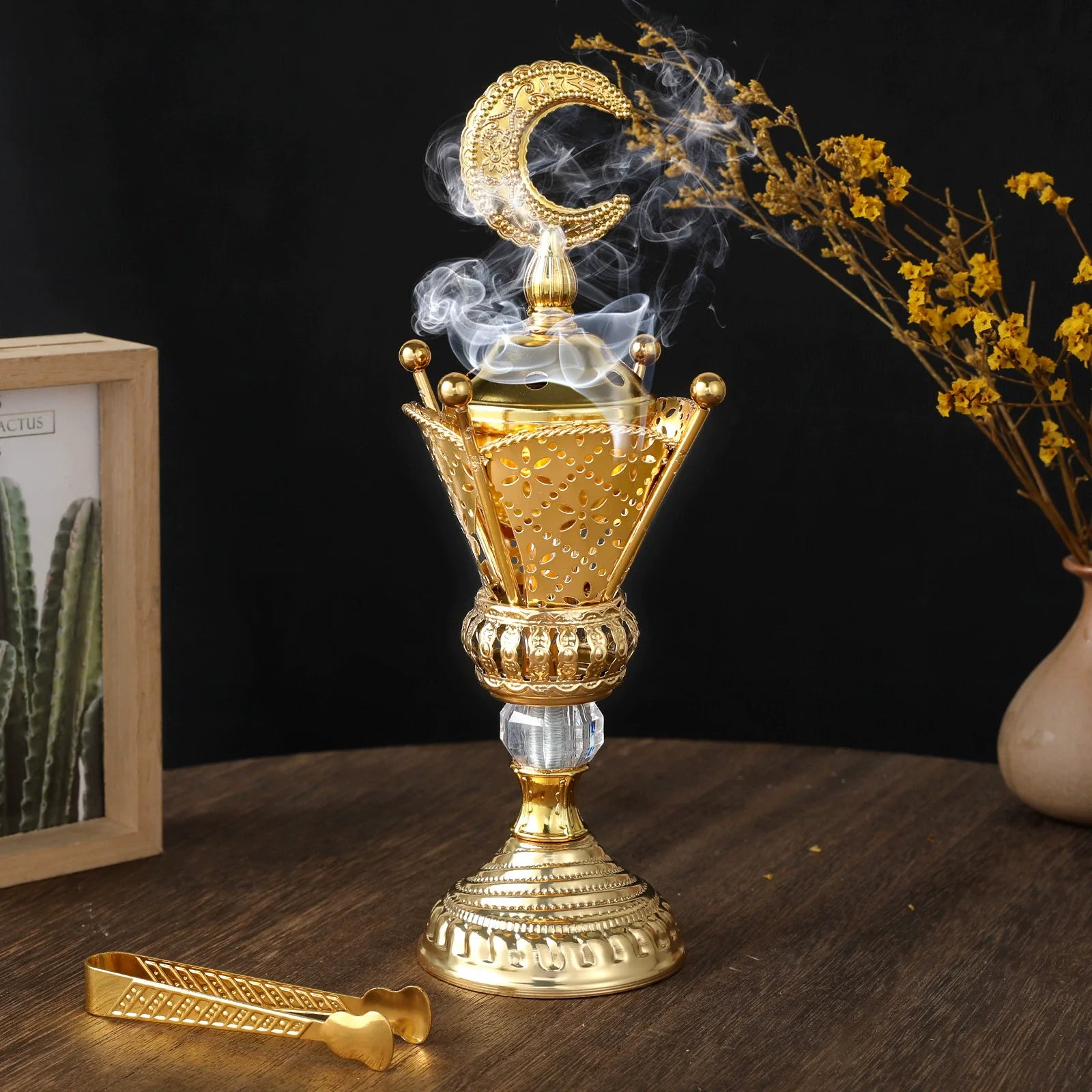 Golden charcoal mabkhara in brushed gold, with crescent handle and ornate base