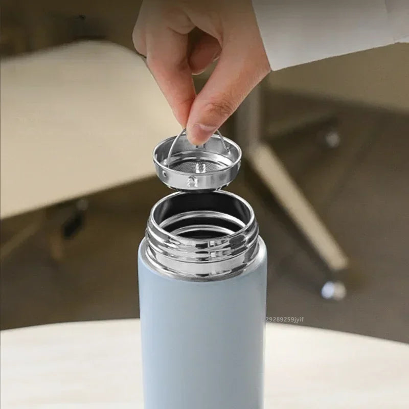 Light blue smart thermos with open cap showing stainless-steel inner rim