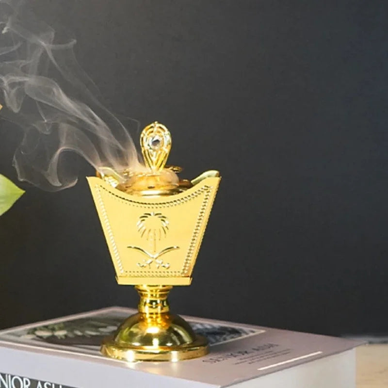 Gold incense holder with crown bowl, lid finial, and smoke rising from the center