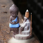 Backflow incense burner, blue-robed Buddha with stone cone incense and flowing smoke