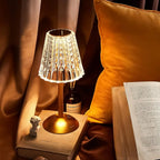 Champagne gold crystal table lamp with lit patterned shade and round gold base