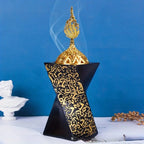 Black resin bakhoor burner with gold finial and engraved Arabic calligraphy
