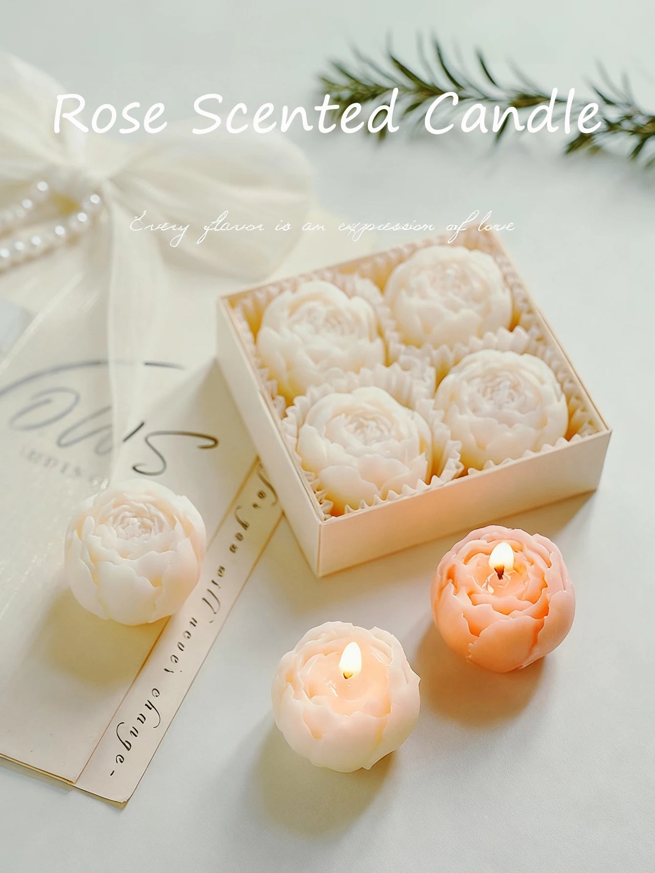 Rose scented candle gift set with white rose candles and a small lit peach rose candle