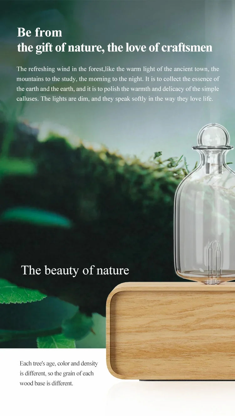 Essential oil diffuser with clear glass bottle and light wood base, close view