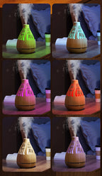 Wood-grain aroma diffuser humidifier with colorful LED light in vent openings.