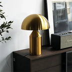 Gold glass mushroom table lamp with rounded dome shade and ribbed body
