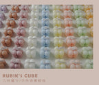 Scattered grid of pastel bubble candles in various colors, each in a clear cube box