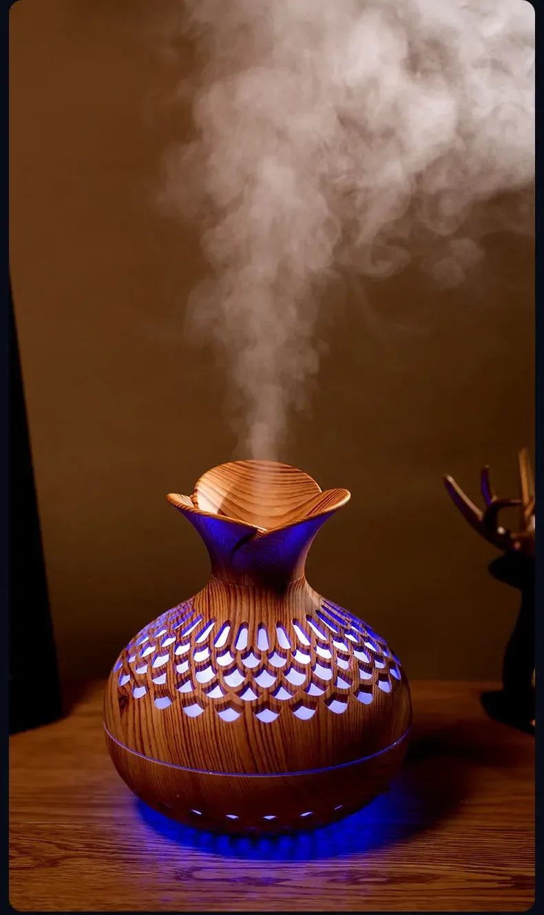 Wood grain aroma humidifier releasing mist with blue-purple LED glow through top vents