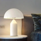 White mushroom table lamp with domed shade and glowing white cylindrical body