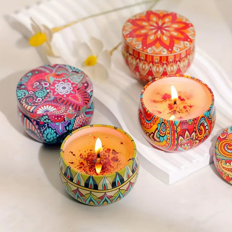 Assorted patterned scented candles with lit flames in colorful round tins