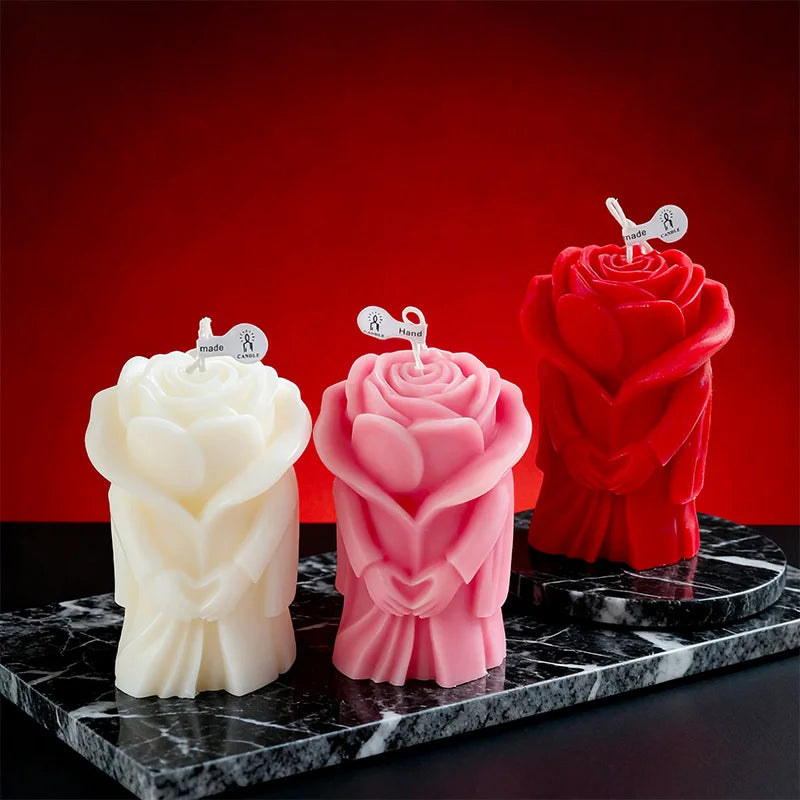 Rose-shaped scented candles: white, pink, and red figures on a dark tray