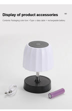 Cordless LED lamp with white shade and black base; includes USB cable and purple battery