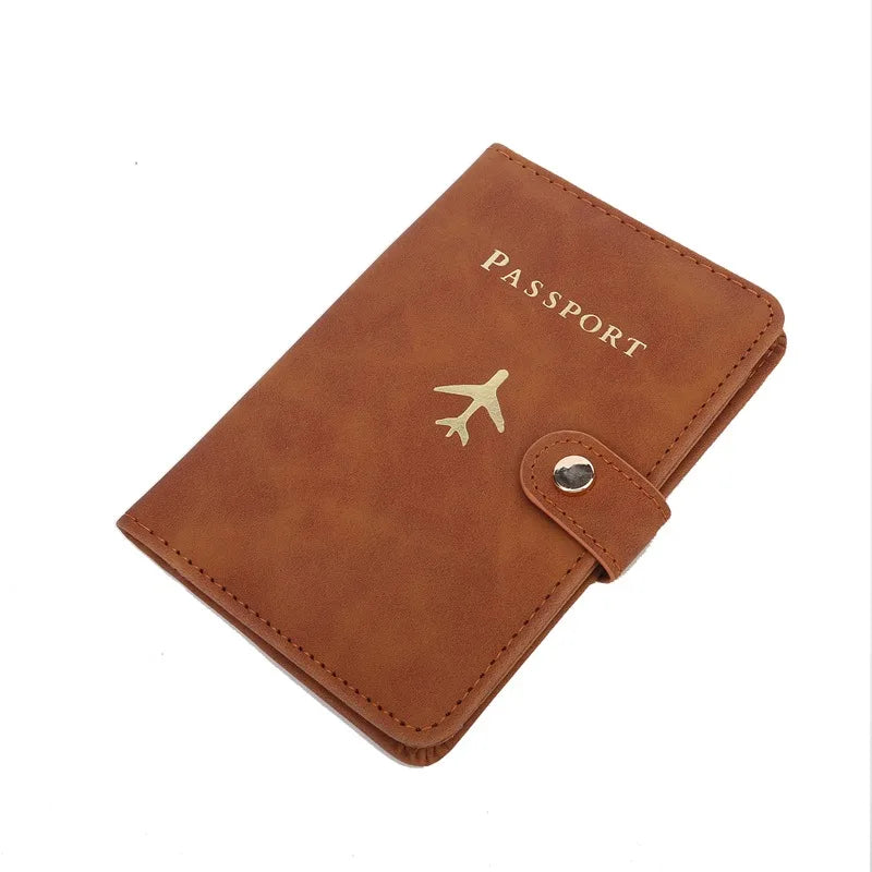 Cognac brown passport cover with “PASSPORT” text, airplane emblem, and snap strap