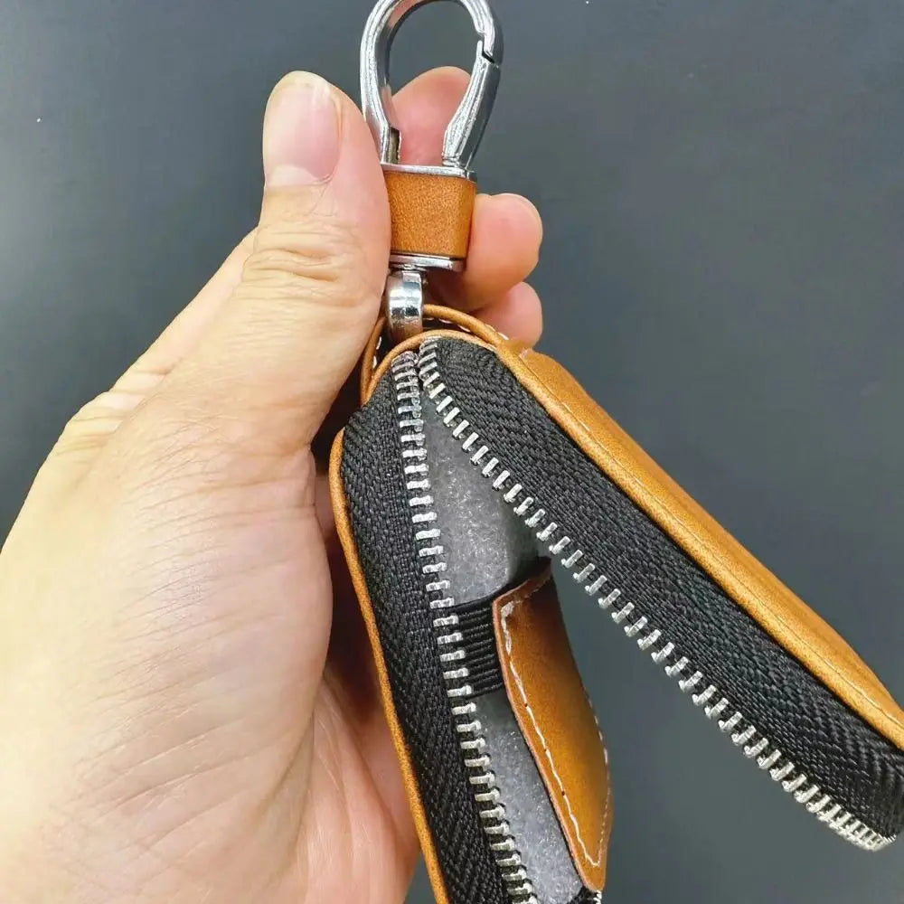 Brown PU leather earphone keychain case with zipper seam and metal carabiner ring