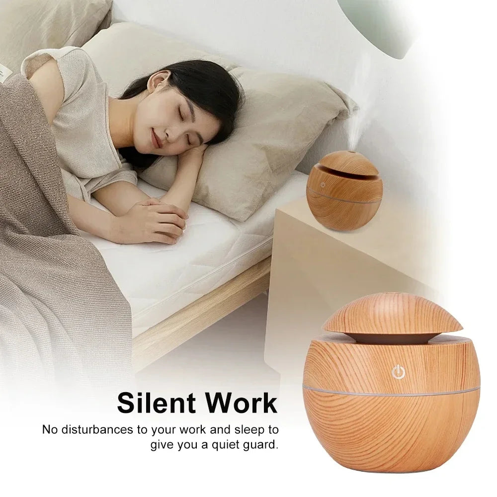 Wood-grain air humidifier and aroma diffuser, round base with domed top and power button.