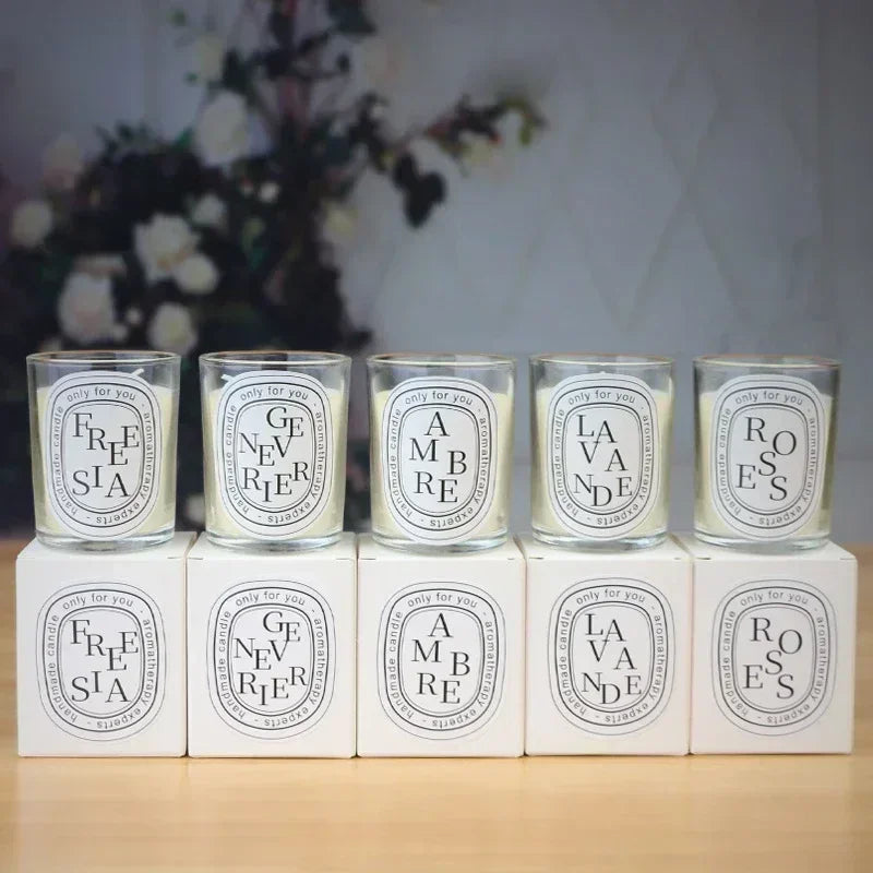 Set of glass jar scented candles with flames; “AMBRE”, “LA VANDE”, “ROSES” labels