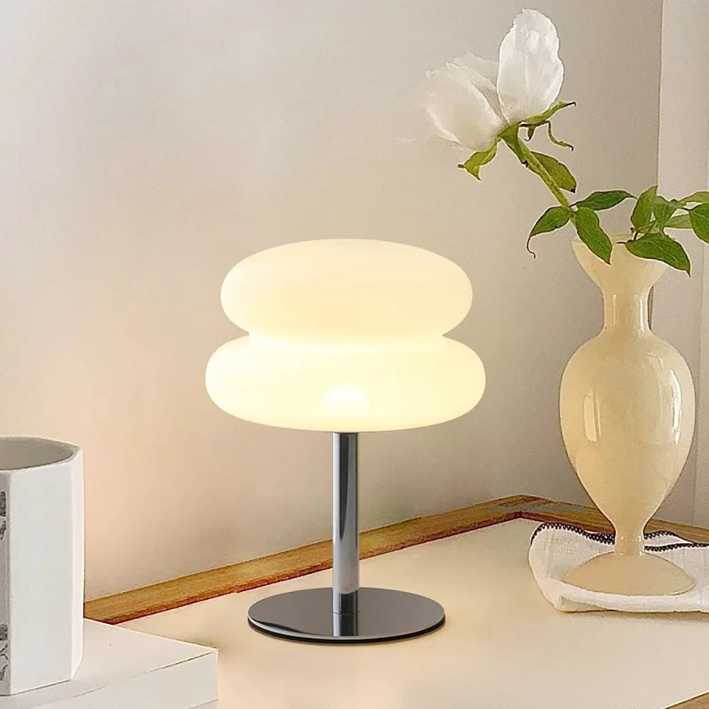 Mushroom USB ambient table lamp lit with warm white light; rounded stacked shade on base.