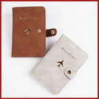 Passport folio set with brown cover and matching light cover with airplane and snap strap