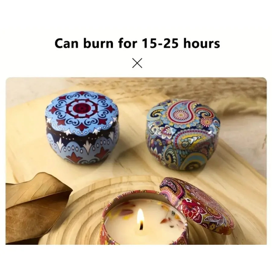 Four patterned scented candle tins with visible wicks and flames