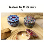 Four patterned scented candle tins with visible wicks and flames