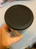 Thermos lid underside close-up with embossed text and sealing ring