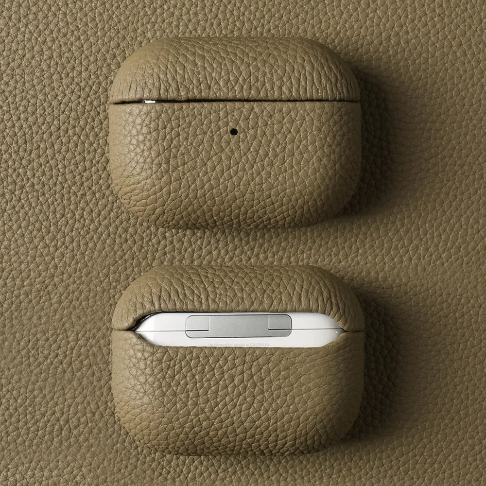 Khaki leather AirPods case, closed with pebble-grain texture and central dot detail