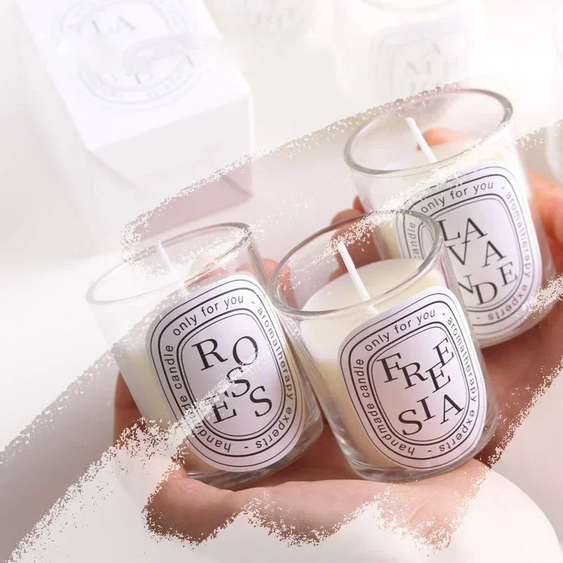 Three glass jar candles with flames; “ROSES” and “FRESTA” labels