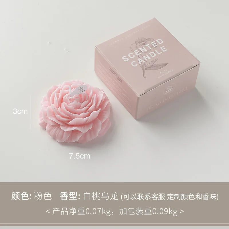 Peony sculptural candle, pale pink flower with wick beside branded gift box, size shown