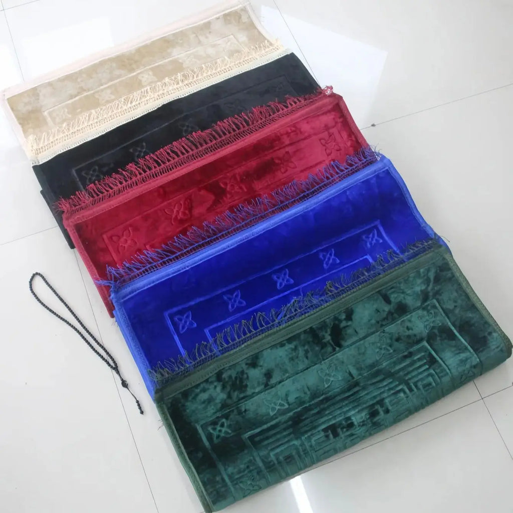 Velvet padded prayer rug with fringed edges, stacked colors: beige, black, red, blue, green.