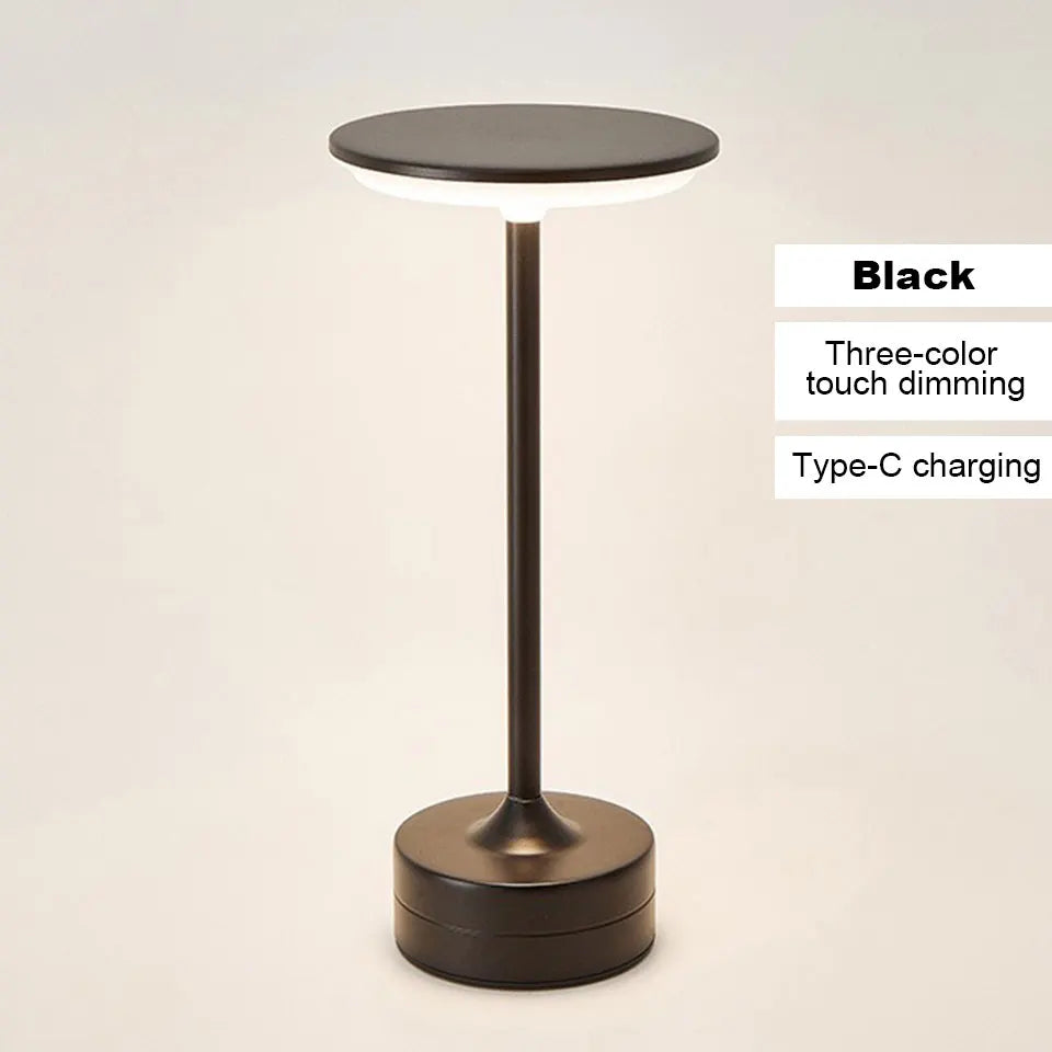 Black cordless reading lamp with round dark top, tall stem, and cylindrical base