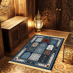 Islamic-style prayer mat with blue patterned center, decorative border, and light fringe