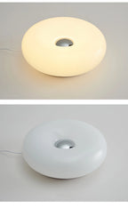 White donut table lamp with center circular opening; top and side views