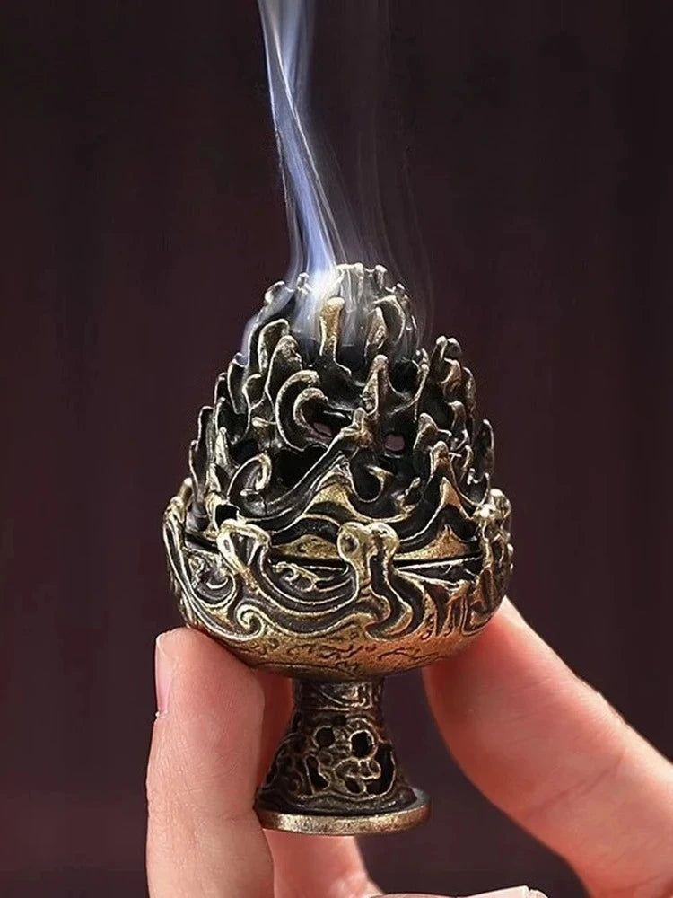 Ornate copper incense censer with flame-like bowl, smoke plume rising from top