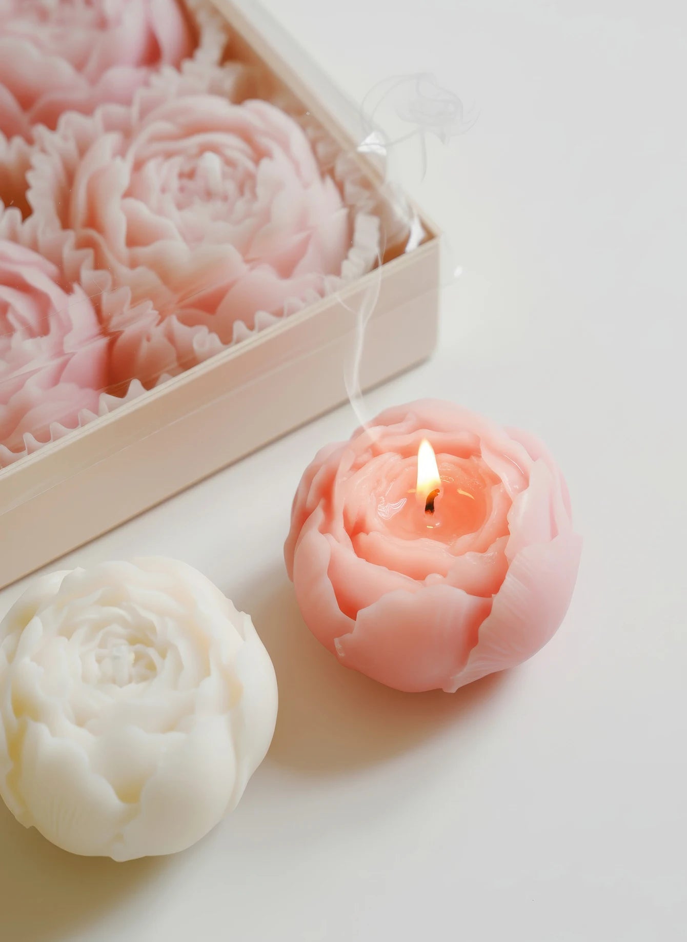 Pink and white rose-shaped soy wax candles in a wooden gift box