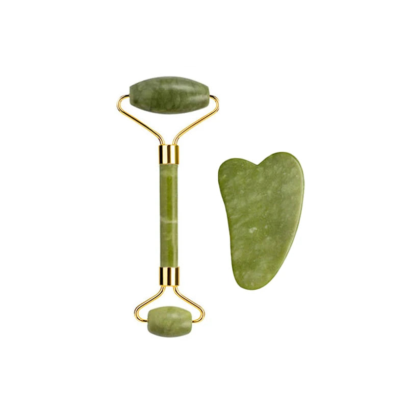 Nephrite jade roller with ribbed face and oval handle, paired with curved gua sha stone