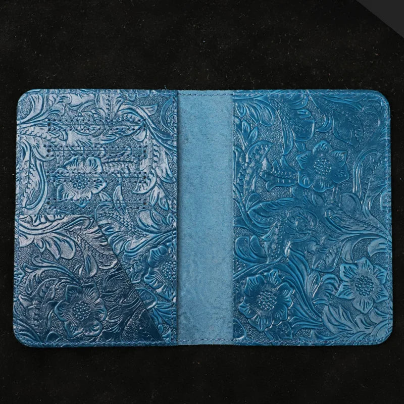 Blue leather travel folio open view with center divider and embossed interior panels