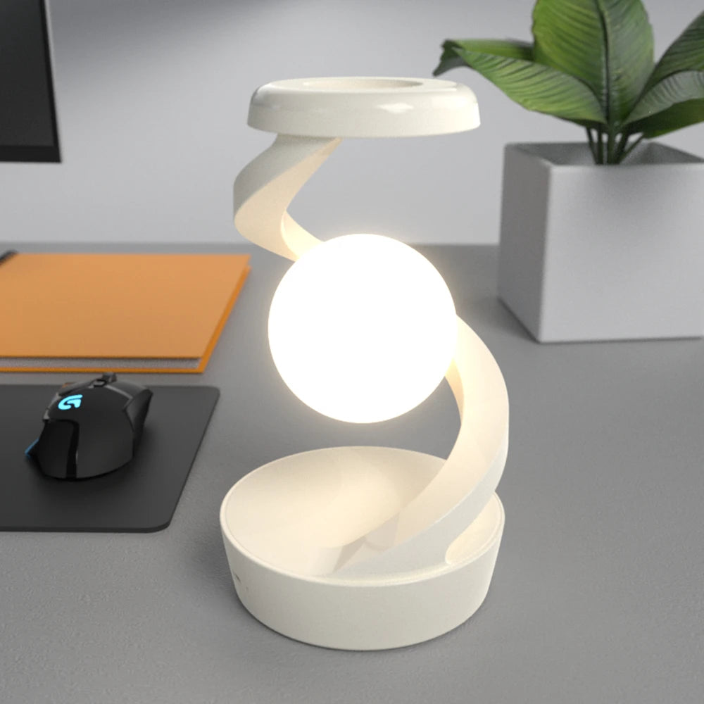 Pearl white floating wireless charging lamp with bright glowing orb and curved light arm