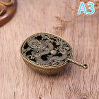 Brass-toned round incense burner with handle, dragon-and-wave relief
