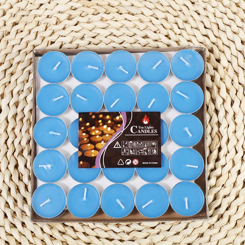 Blue tea light candles in a box tray, each with a white wick