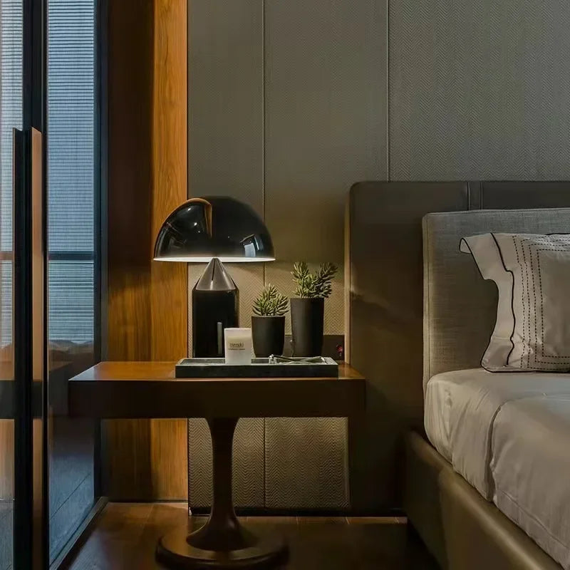 Black mushroom table lamp with gold underside and cylindrical base