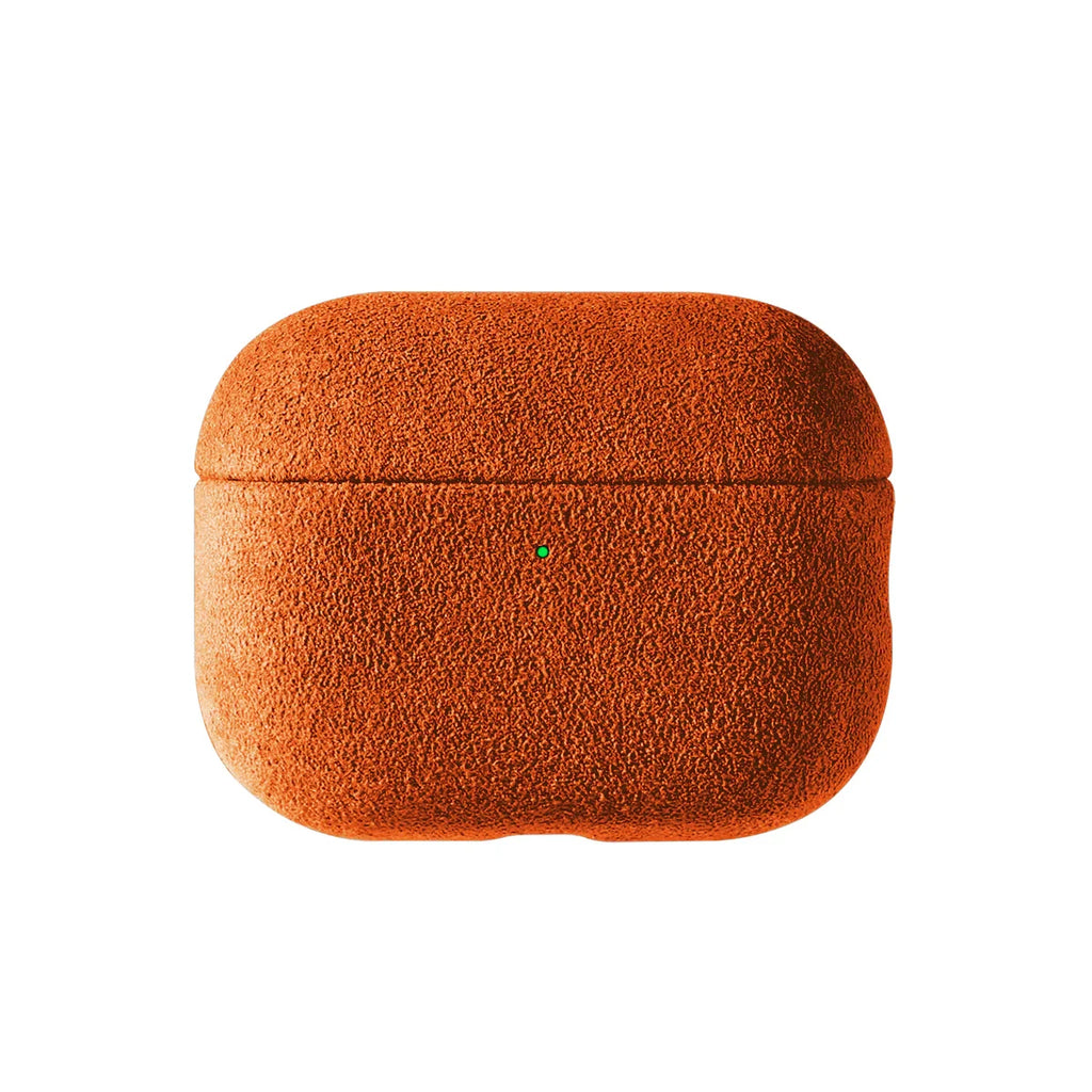 Alcantara AirPods case in amber orange, closed with small charging port marker