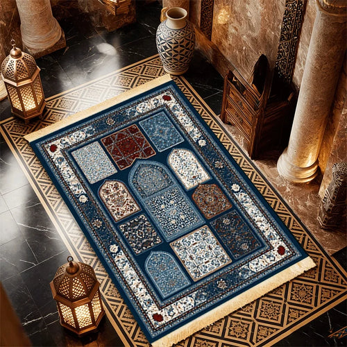 Islamic-style prayer mat with blue center panels, ornate border, and off-white fringe